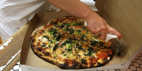 en pizza is prepared for a take out customer at Frank Pepe Pizzeria on Wooster Street in New Haven's Little Italy.