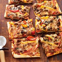 Mi've gathered all of the best ingredients from a hot and saucy hero sandwich — Italian sausage, peppers, and cheese — and put them on a kid-friendly pizza.
